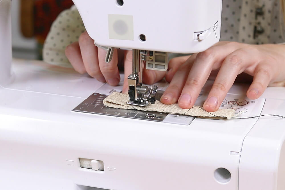 Finishing webbing using a sewing machine